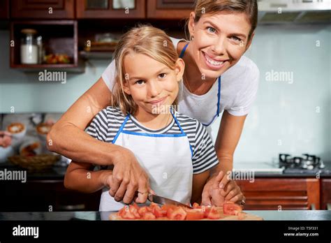 Mother Teaching Daughter How To Cook Stock Photo Alamy