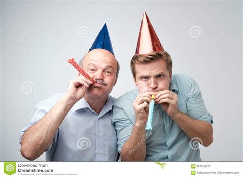Mature Man And His Young Son Celebrating Happy Birthday
