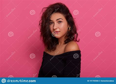 Brunette Female Posing With Bare Shoulders Against Pink Wall Having
