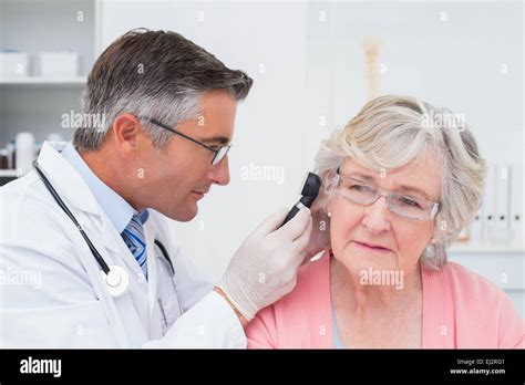 Doctor Examining Female Patients Ear With Otoscope Stock Photo Alamy