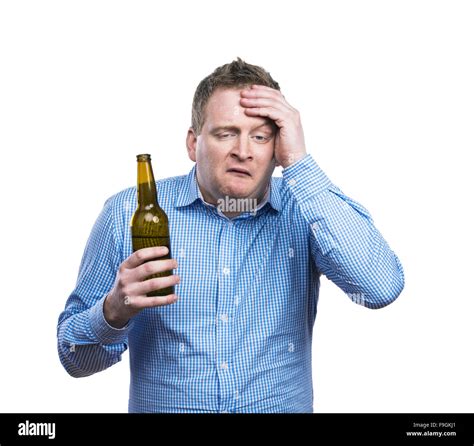 Funny Young Drunk Man Holding A Beer Bottle Studio Shot On White