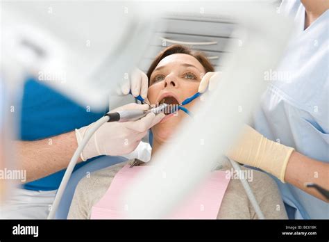 Male Dentist And Assistant Examining Patient S Teeth Stock Photo Alamy