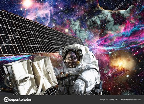 International Space Station And Astronaut In Outer Space Over The