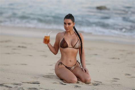 Kim Kardashian Poses On The Beach In Skimpy Bikini