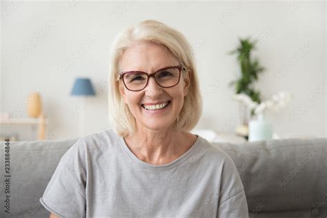 Smiling Middle Aged Mature Grey Haired Woman Looking At Camera Happy