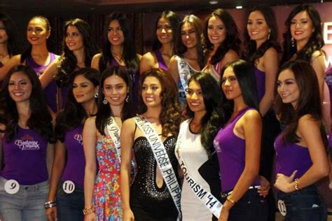 A Group Of Women Standing Next To Each Other In Front Of A Sign That Says Miss India