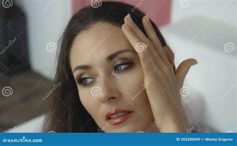Young And Beautiful European Girl Close Up Touches The Skin Of The Face With Tender Hands Stock