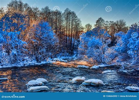 Rough River In Winter With Snow Covered Trees And Steam Stock Photo