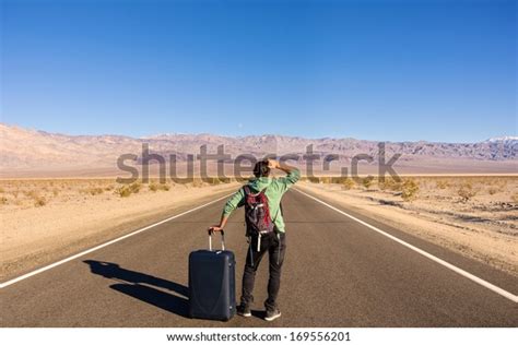 Single Man Walking Alone Into Desert Stock Photo Edit Now 169556201