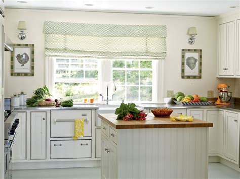 White Cottage Kitchen Featuring Cabinets Sconces And An Orange Stand