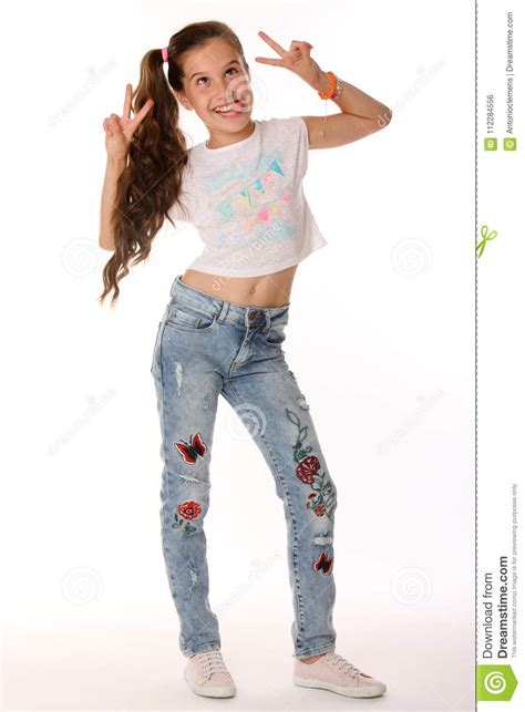 Portrait Of Happy Teenage Girl In Blue Jeans With A Bare