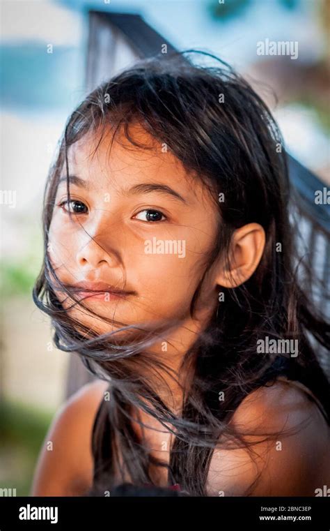 a pretty filipino girl smiles on las cabanas beach el nido