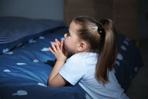 Little Girl Saying Bedtime Prayer Near Bed In Room Stock Photo Image