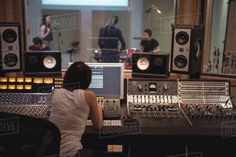 Audio Engineer Using Sound Mixer In Recording Studio Stock Photo