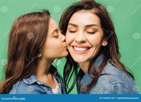 Adorable Daughter Kissing Happy Mother Cheek Isolated Stock Photo