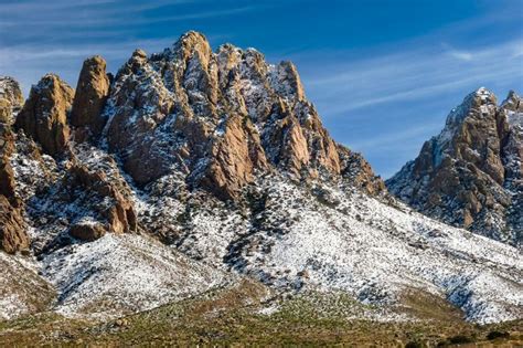 The Mountains Are Covered In Snow On A Sunny Day