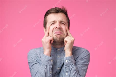 Premium Photo Sad Young Man Crying On Pink Background