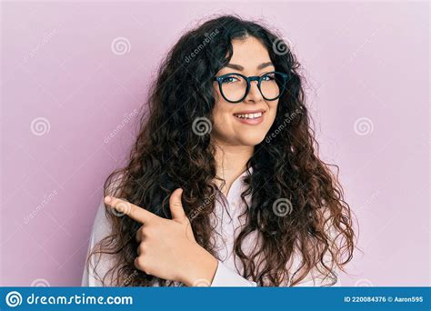 Young Brunette Woman With Curly Hair Wearing Casual Clothes And Glasses