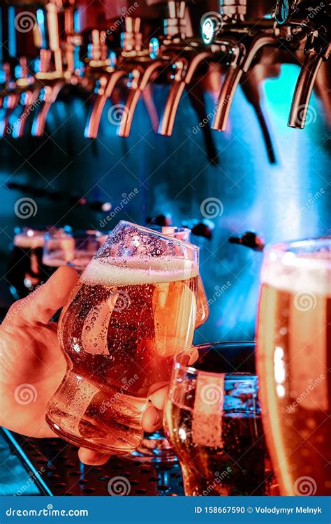 Hand Of Bartender Pouring A Large Lager Beer In Tap Stock Photo Image