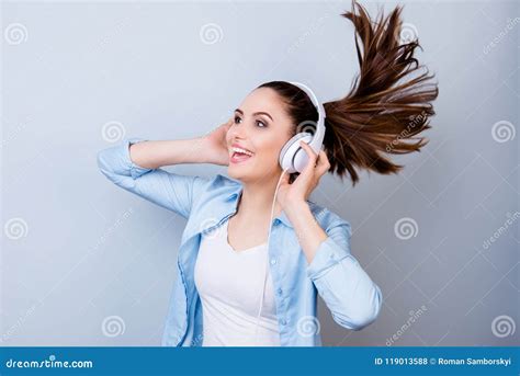 Cheerful Smiling Young Woman In Blue Listening To Music An Headphones