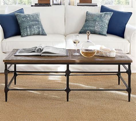 A beautiful acacia wood top and metal legs make this piece easy to add into. Parquet Reclaimed Wood Rectangular Coffee Table | Pottery Barn