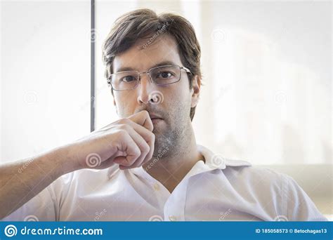 Man Looking Directly At The Camera Making A Conference Call Stock Image