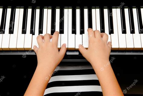 Premium Photo Hands Of Kid Playing Piano