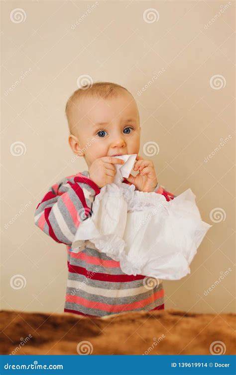 Baby Holding A Nappy In Mouth And Looking Stock Photo Image Of