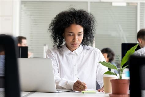 Focused Black Employee Take Notes Working In Shared Office Stock Image