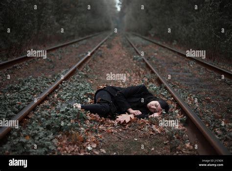 Caucasian Woman Laying Between Railroad Tracks Stock Photo Alamy
