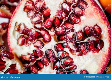 Pomegranate Fruit Cut In Half Up Close On Seeds Inside Stock Photo