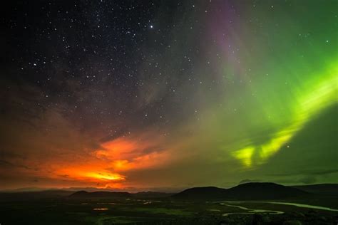 Nightsky Split Between The Cold Green Of An Aurora And The Fiery Red Of