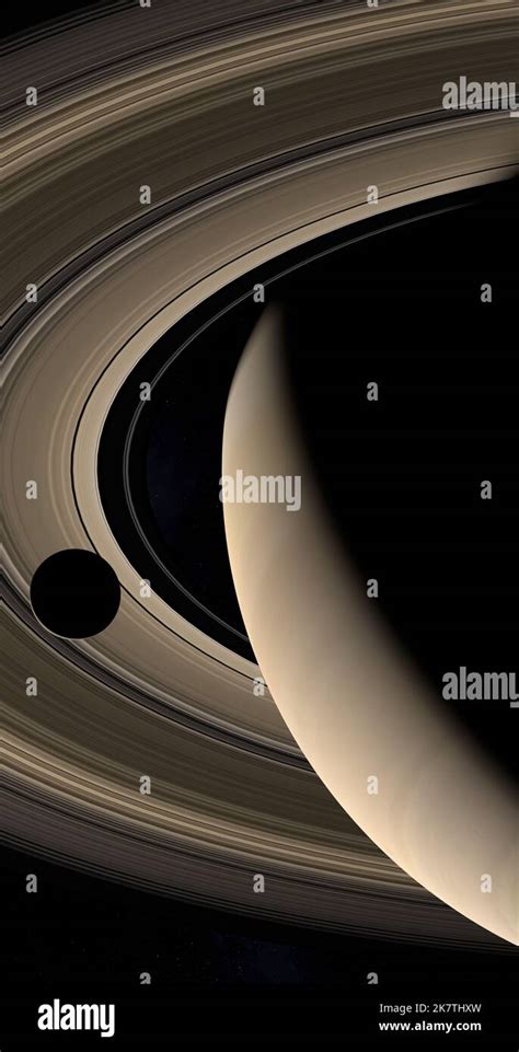 Moon Or Satellite Orbiting Around Saturn Planet And Her Rings In The