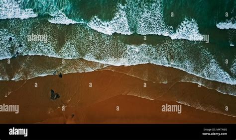 Aerial View From Flying Drone Of Ocean Waves Crushing On Beach Stock