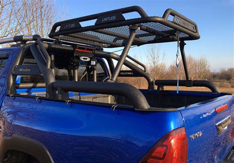 The Back End Of A Blue Pick Up Truck With A Rack On Its Bed