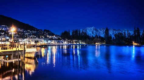 Lakeside Town On A Blue Night Night Blue Town Boats Mountains
