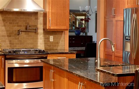 Cherry wood comes in different shades. Natural cherry cabinets in kitchen with black granite, and ...
