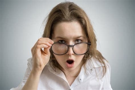 Young Funny Woman With Glasses Is Shocked And Surprised Stock Photo