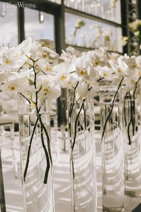 White Orchid Centrepieces In Tall Vases Floating Orchid Centrepieces All White Wedd White