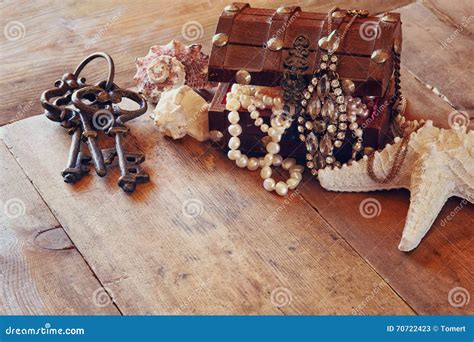 White Pearls Necklace In Treasure Chest Next To Seashells Stock Image