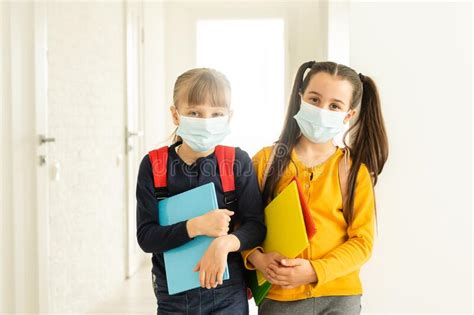 Two Pupils Friends In Protective Masks With Backpacks Day At School