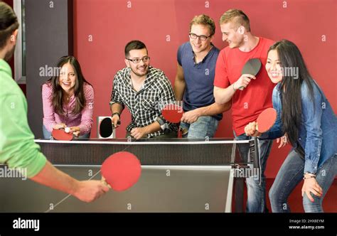 Group Of Happy Young Friends Playing Ping Pong Table Tennis Fun