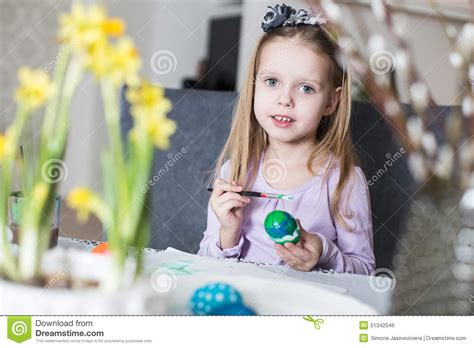 A Happy Little Girl Coloring Easter Eggs Stock Photo Image Of