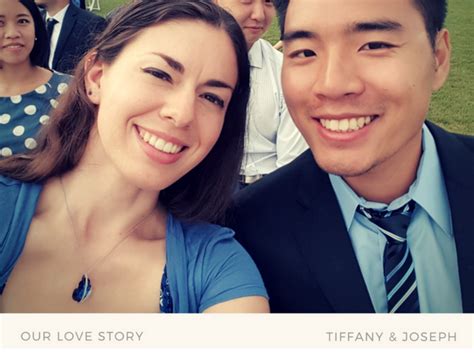 a man and woman posing for a photo in front of other people at an event