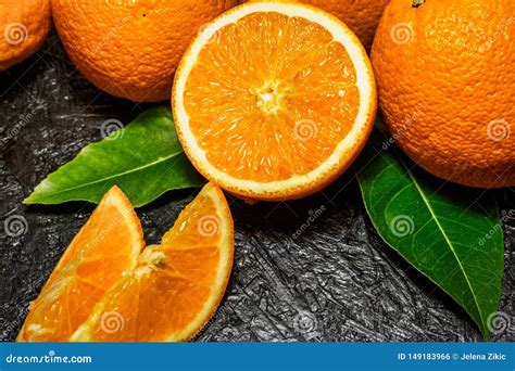 Sliced And Whole Oranges On Dark Background Stock Photo Image Of