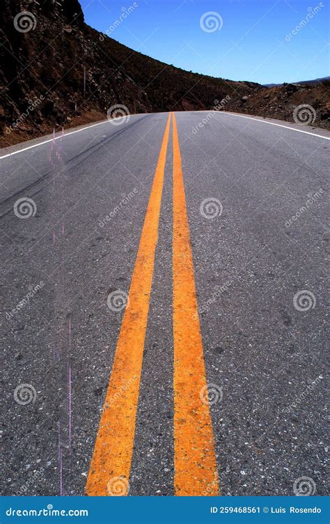 Panoramic View Of A Long Straight Road Cutting Through A Barren Scenery
