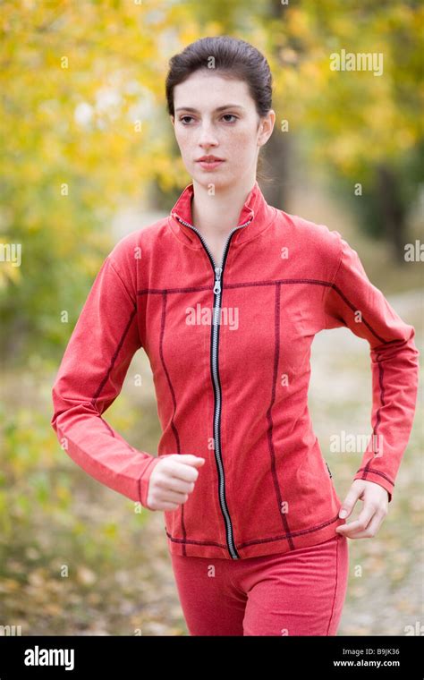 Young Woman Jogging In A Park Stock Photo Alamy