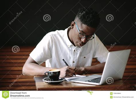 Freelancer Working On Laptop Computer At Coffee Shop Stock