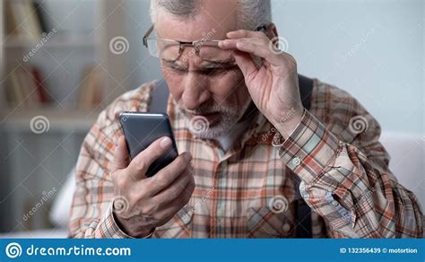 Bewildered Old Man Looking At Cellphone New Technology Complicated For