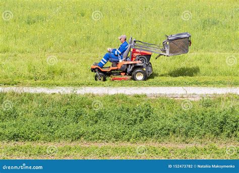 Mature Man Driving Grass Cutter In A Sunny Dgardener Driving A Riding